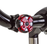 Close-up of the ML-400 Multi Light on a bicycle handlebar, showcasing its sleek titanium build, ideal for scooters and bikes.