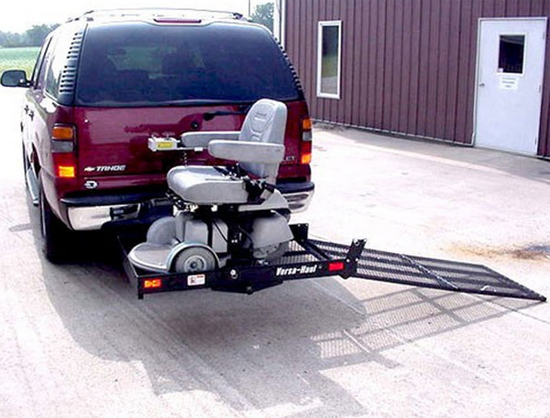 Mobility Scooter & Power Chair Carrier mounted on a vehicle's tow hitch, featuring a fold-up ramp for easy loading and a robust design for safe transport.