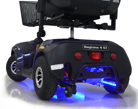 Multi-Color LED Light Kit for Mobility Scooters & Power Chairs, featuring a blue and black vehicle with a basket on top, blue lights, and multiple light functions controlled by a remote.