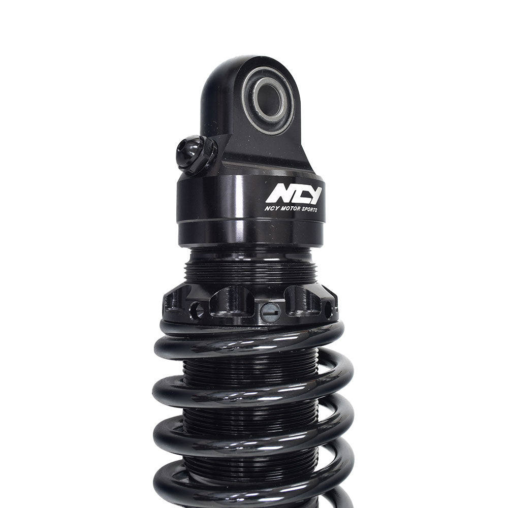 Rear Shocks for the Yamaha Zuma 125 featuring a black coil with a round lens and white text, designed for high performance and durability, sold as a pair.