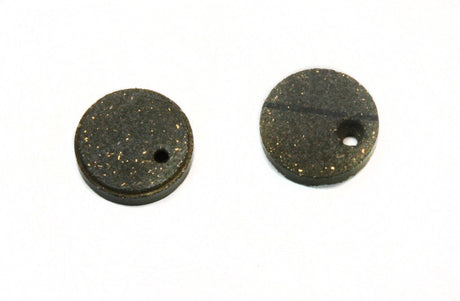 Organic Brake Pads for Polaris Snowmobiles (1975-1991) shown in a close-up image, featuring round, black metal pads with central holes, highlighting their durable design for extreme temperature and vibration resistance.