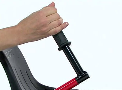 Hand holding the Drift Bar Extender for the Razor Crazy Cart DLX (Version 1+), showcasing its black and red handle designed for easy grip.