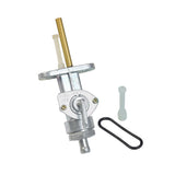 Petcock Fuel Valve for Yamaha DT100, DT125, DT175, DT250, DT360, & DT400 Dirt Bikes, featuring a metal body, rubber gasket, and a small valve for fuel flow control. Ideal for carburetor systems.