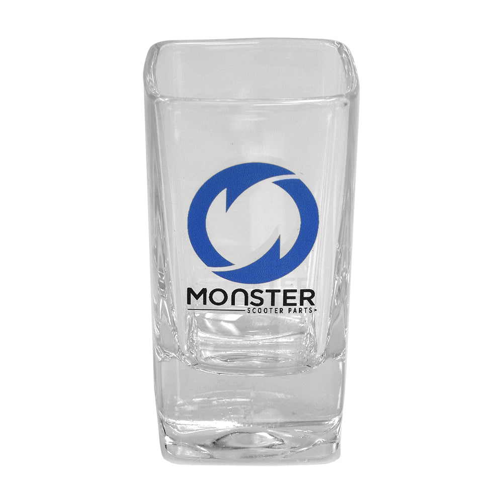 Monster Scooter Parts Shot Glass featuring a clear glass with a blue logo and black text, designed to hold 1.5 oz.