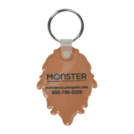 Monster Scooter Parts Sasquatch Keychain close-up, showing soft PVC Sasquatch figure with attached ring for keys and a visible logo and contact details on the back.