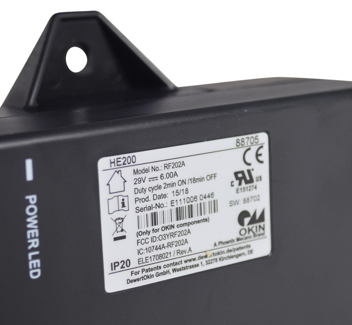 Close-up of the Motor Control Box for the Pride Infinity Oasis LC-580I Infinite-Position Lift Chair, showing a label, a white circle, a black triangle with a hole, and various connectors.