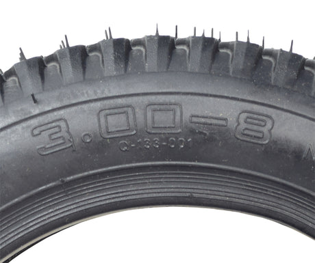 Close-up of a 3.00-8 x 14x3 Pneumatic Black Tire with Q133 Tread and Inner Tube Set, showcasing the detailed tread pattern and robust construction ideal for Pride Pursuit XL mobility scooters.