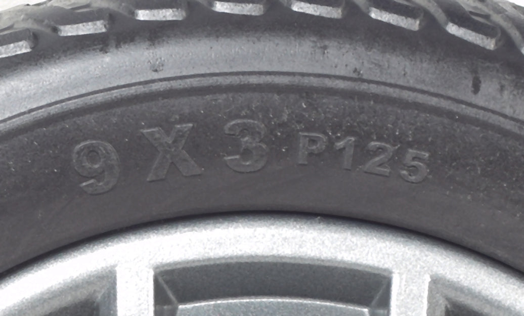 Close-up of the 9 Foam-Filled Drive Wheel Assembly for the Go-Go Go Chair (2016 and Newer), showcasing the black PU foam-filled tire and Tri-spoke Euro Gray rim.