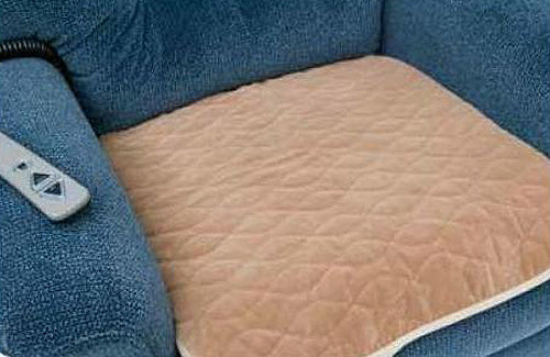 Protective Seat Pad for Pride Lift Chairs displayed on a blue chair, featuring a sand-colored, three-layer fabric designed to protect upholstery from spills and leaks. The pad fits most lift chair models.