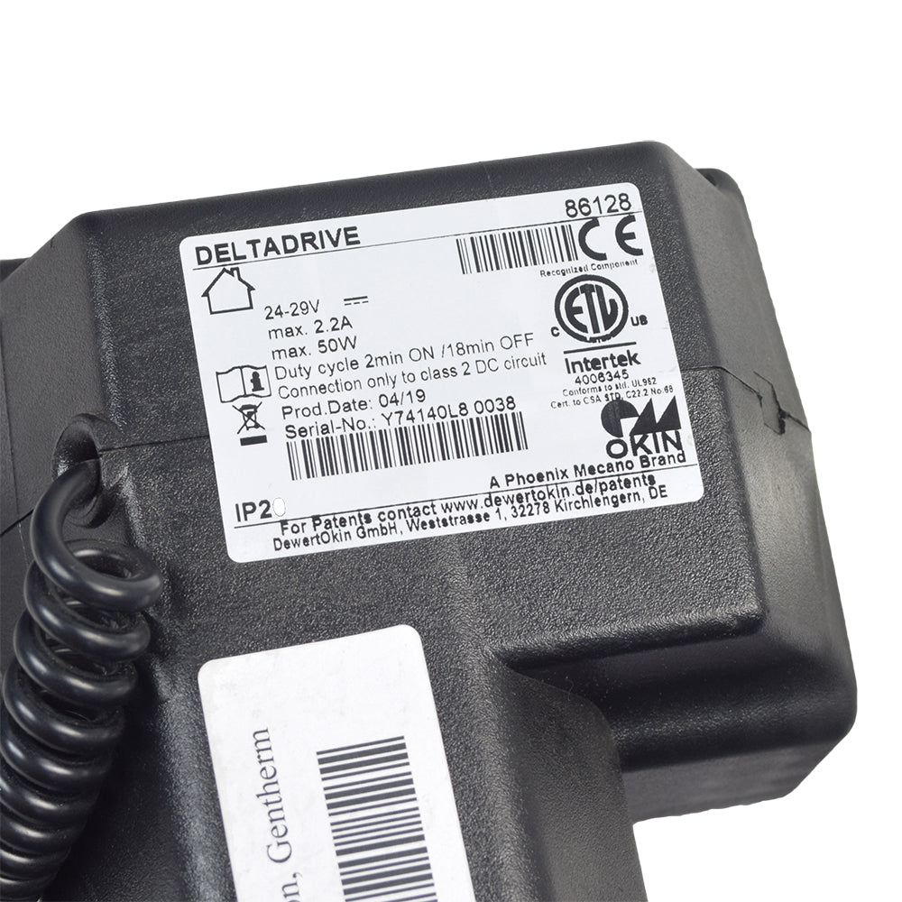 Close-up of the OKIN DeltaDrive 86128 3-Position Single Lead Actuator Motor for Mega Motion Lift Chairs, featuring a black device with a cord and a visible label.