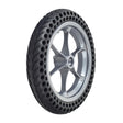 Drive Wheel Assembly with Silver Rim for the Jazzy Passport Power Chair, featuring a flat-free tire with internal honeycomb construction, shown in close-up detail highlighting the tire tread and black rim.