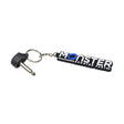 Key for the Merits Cruiser Q, Mini Coupe, Pioneer 1, & Roadster mobility scooters, featuring a close-up of the key chain with a key ring and a black and white Merits logo.