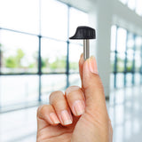 Hand holding a Key (Stereo Plug Style) with Round Knob Head for Pride Scooters, resembling a black and silver stereo plug with a round knob at the top for attaching a key ring.