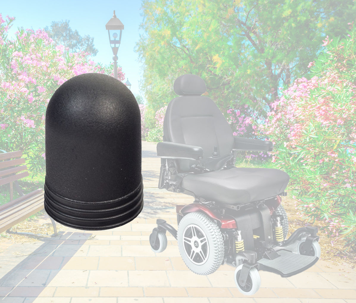 Joystick Knob for Dynamic Joystick Remotes (Shark, SPJ+, A-Series) shown close-up, highlighting its black color and textured grip, positioned next to a power chair wheel and tire.