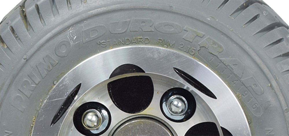 Close-up of the Flat-Free Rear Wheel Assembly for Pacesaver Plus III Scooters, showcasing the Primo Durotrap tread design on the tire, emphasizing its durability for mobility scooters.