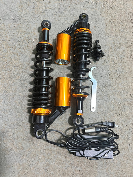 13-1/2 Adjustable Air Shocks for ATVs, Dirt Bikes & Go-Karts (Set of 2) (Blemished) showcasing a black and orange shock absorber, emphasizing its sturdy springs and adjustable features for enhanced ride quality.