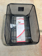 Market-Style Rear Basket for Bicycles (Axiom) (Blemished): A black, vinyl-dipped steel wire mesh basket mounted on a bike's rear rack, containing a red and white package.