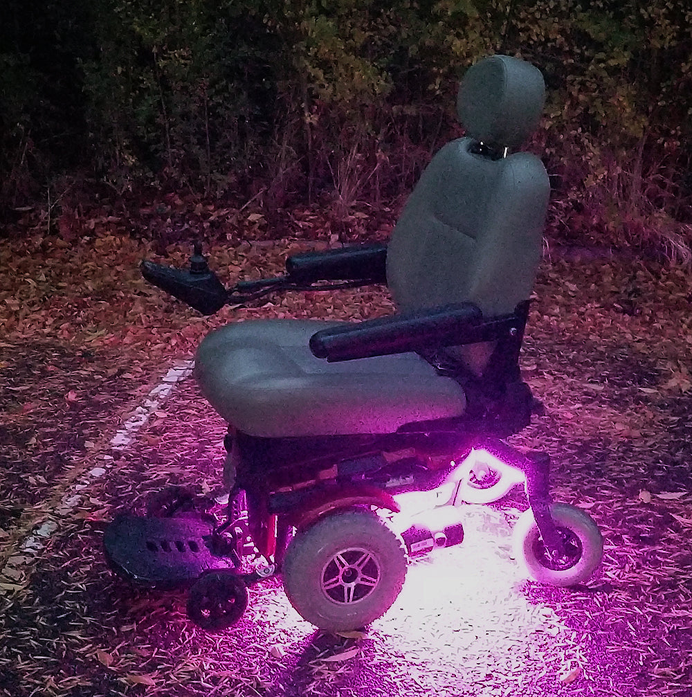 Multi-Color LED Light Kit for Jazzy Power Chairs, featuring a wheelchair illuminated with vibrant purple lights, perfect for adding customizable, weather-resistant LED strips for a dazzling, psychedelic effect.