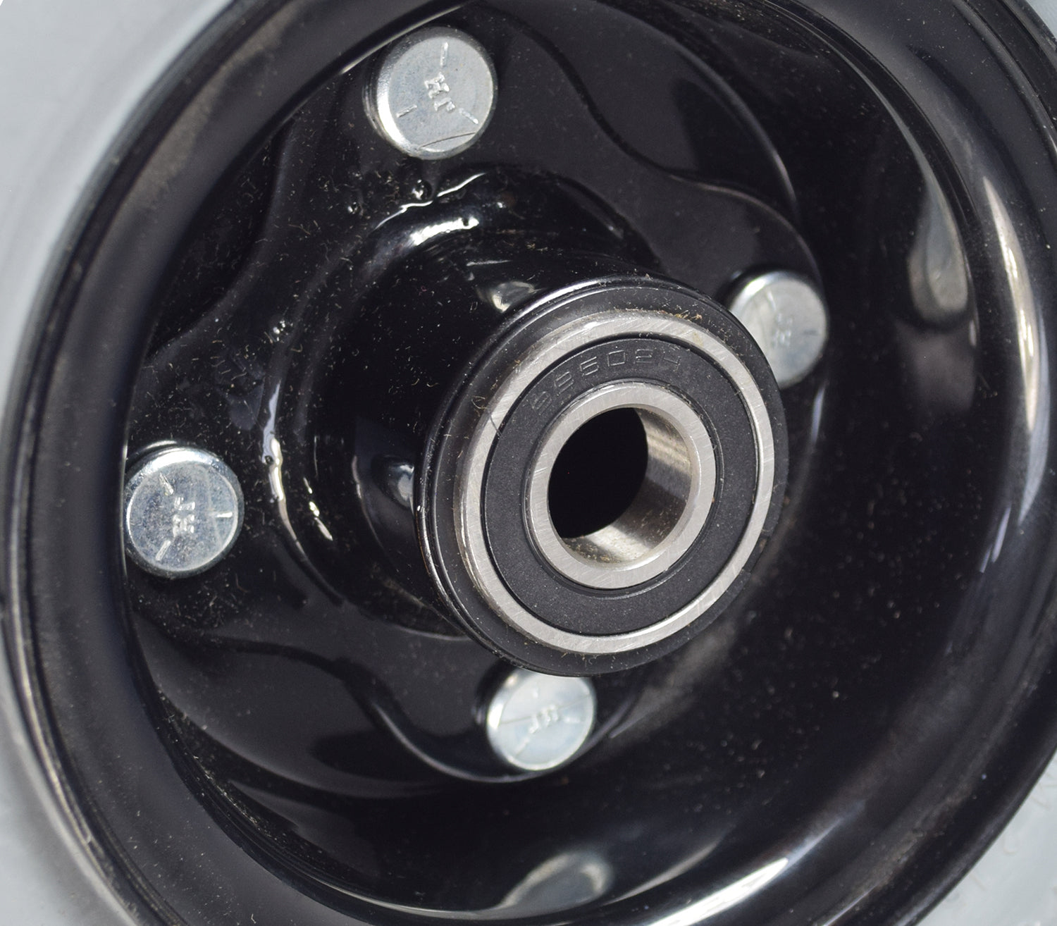 Close-up of the 9x3 (2.80/2.50-4) Pneumatic Caster Wheel Assembly for Invacare Storm Series Power Chairs, showcasing the detailed metal and black components essential for power chair mobility.