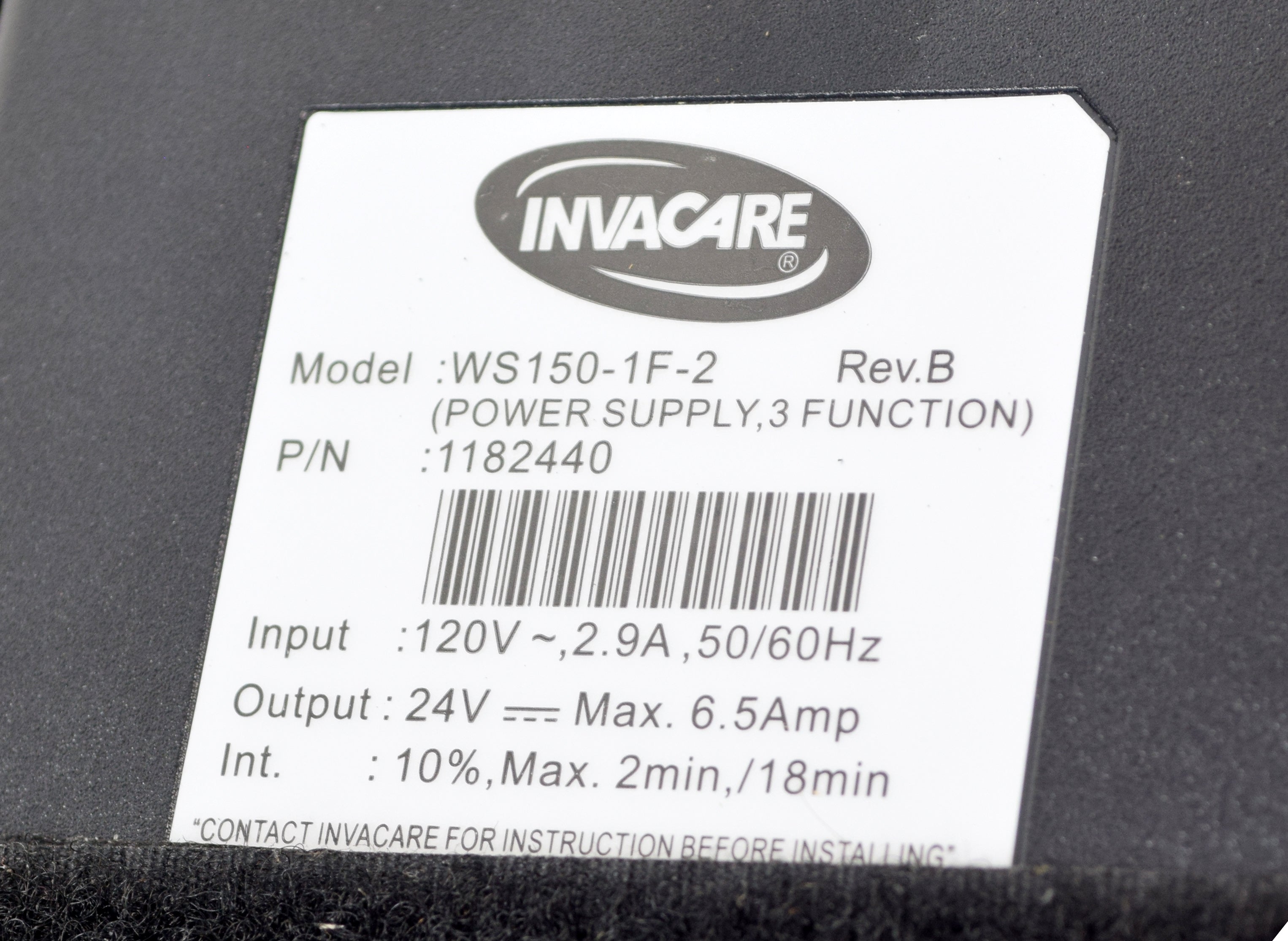 Power Supply for the Invacare G-Series Full Electric Bed (G5510), displaying a label with bar code and logo details, indicating it as a direct replacement unit.