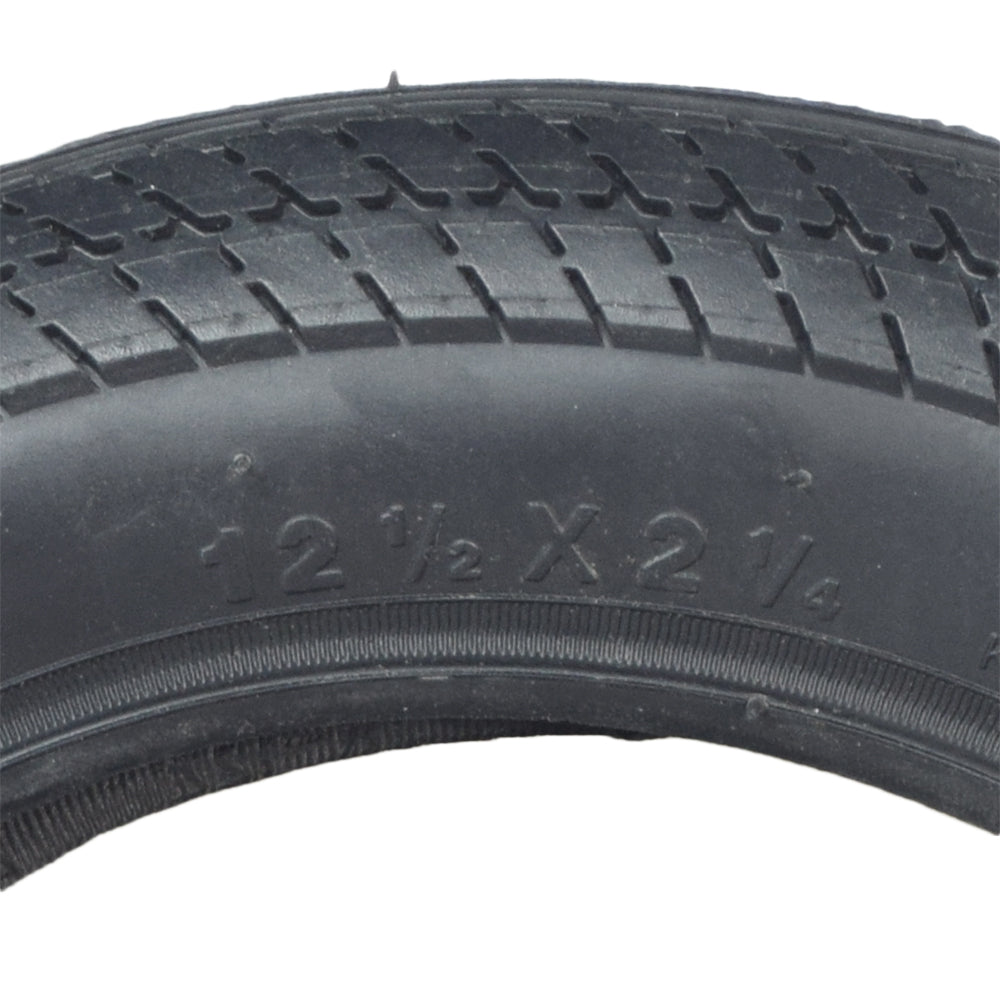 12-1/2x2-1/4 Scooter Tire with K912 Tread, featuring a close-up view of the detailed v-shaped sipes on the black tire's surface for enhanced street performance.