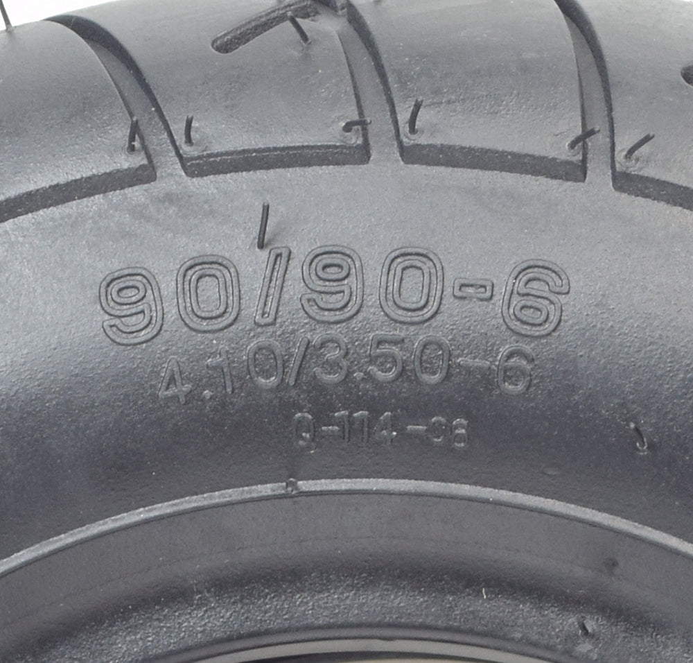 Close-up of a 4.10/3.50-6 (90/90-6) front tire with Q114 tread for the Minimoto Maxii and TrailMaster 163 Mini, showcasing detailed tread patterns and sidewall markings.