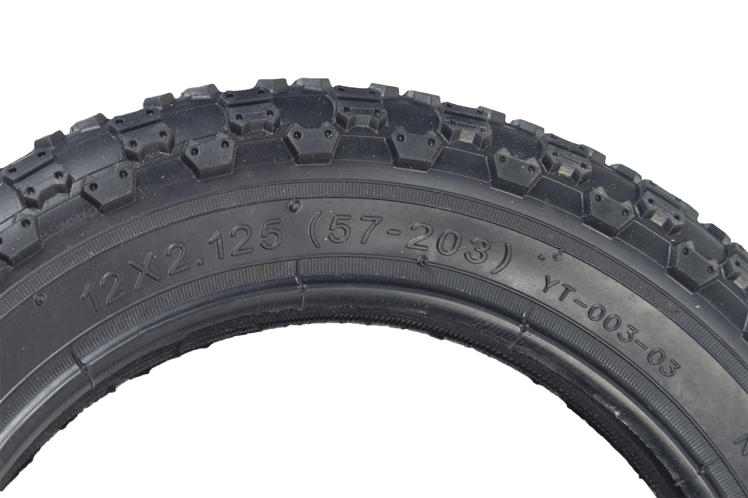 Close-up of the 12-1/2x2-1/4 (57-203/62-203) Tire and Tube Set with Knobby Tread, showing intricate tread pattern and partial view of carved numbers on the tire surface.