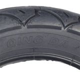 12-1/2 x 2-1/4 (57-203/62-203) Tire for Schwinn S350 electric scooter, featuring black tread with radiating grooves for traction, suitable for use with optional heavy-duty thorn-resistant inner tube.