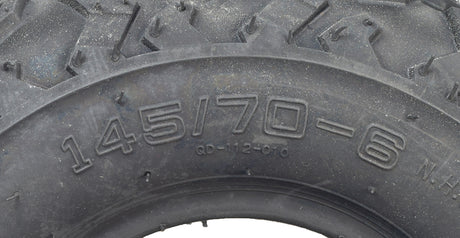 Close-up of a 145/70-6 Tire with V-Tread for the Massimo MM-MB100 Mini Bike, highlighting its aggressive V-tread pattern designed for optimal performance on muddy and loose surfaces.