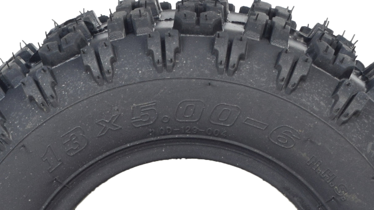 Close-up of the 13x5.00-6 ATV, Go-Kart, & Dune Buggy Tire with Q129 Tread, showcasing its aggressive tread pattern designed for superior grip on loose surfaces.