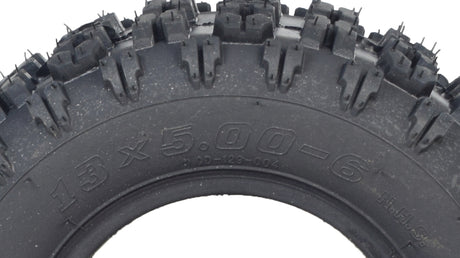 Close-up of the 13x5.00-6 Monster Moto / Mega Moto Go-Kart Tire, showcasing its aggressive tread pattern suitable for both dirt tracks and blacktop surfaces.