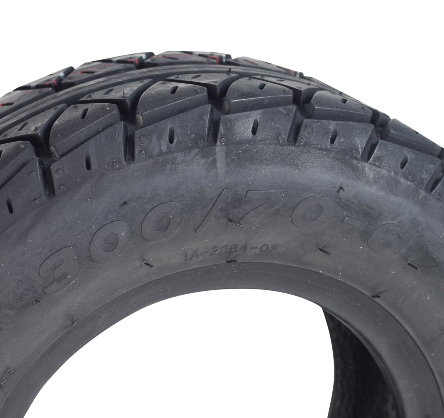 Close-up of a 4.10/3.50-4 Pneumatic Scooter Tire with Q110 Tread, showcasing detailed tread patterns and black rubber texture.