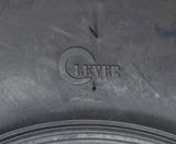 Close-up of a 145/70-6 tire with an aggressive V-tread pattern designed for Baja Blitz, Dirt Bug, Doodle Bug, and Racer mini bikes, ideal for muddy, sandy, and gravel surfaces.