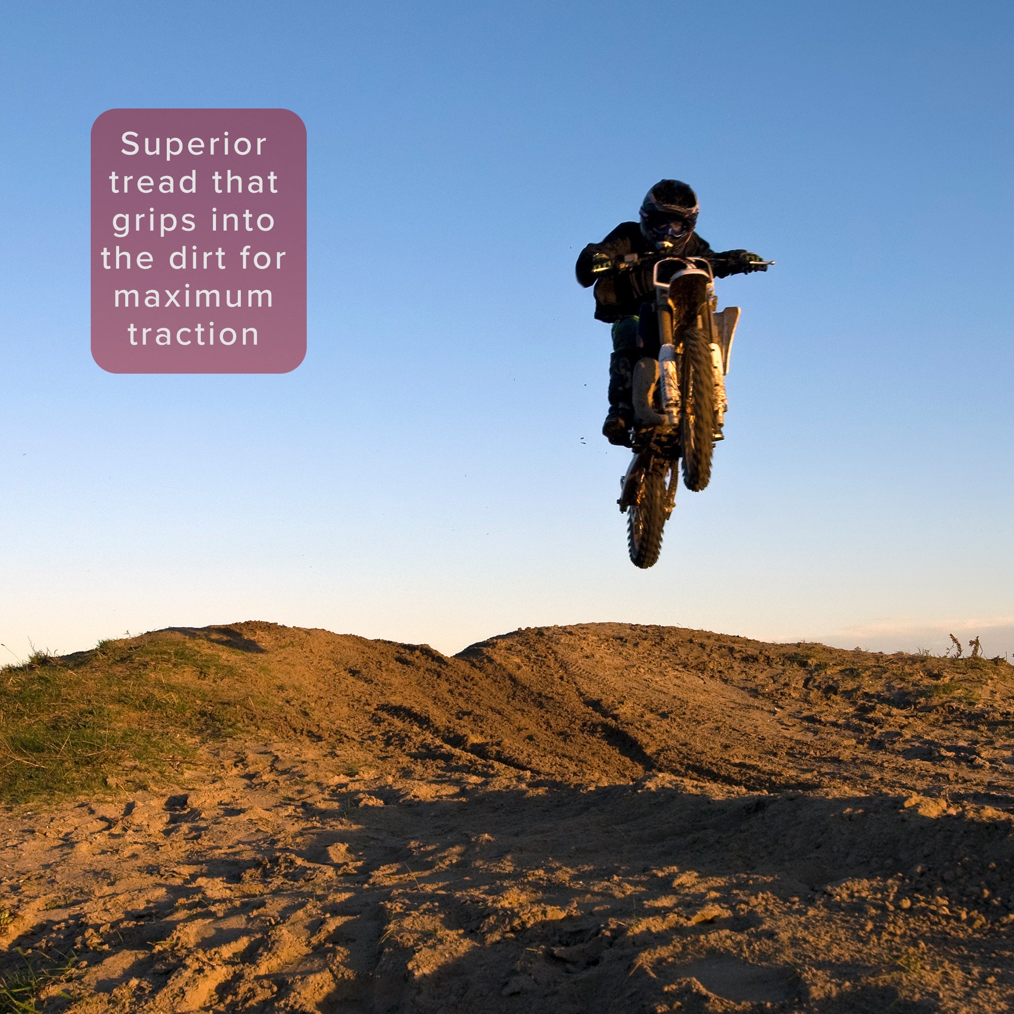 3.00-12 (80/100-12) Tire with JK620 Knobby Tread for Baja, Coolster, & Honda Dirt Bikes, shown in action on a motorcycle jumping over a dirt hill during an outdoor motocross stunt.