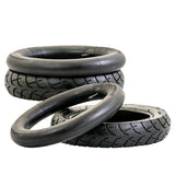 12-1/2x2-1/4 (57-203/62-203) Kick Scooter Tire with Wide Tread, featuring a close-up view of its robust rubber tread, stacked among other tires.