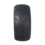 110/50-6.5 Tire for the Motovox MBxXSe Micro-Mini Bike, featuring a close-up of its shallow grooved tread pattern for excellent traction without damaging the lawn.