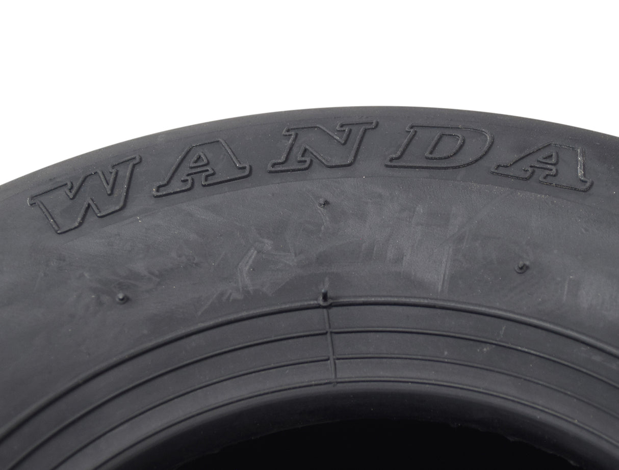 Close-up of the 11x7.10-5 Tubeless Slick Tire for Drift Trikes & Go-Karts, highlighting the smooth, treadless surface designed for high-velocity speed and low traction.