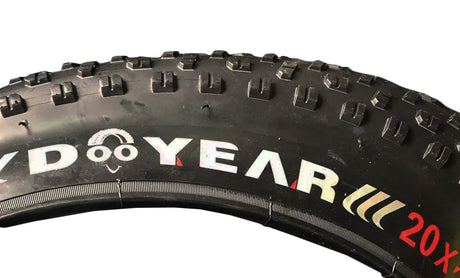 Close-up of a 20x4 Knobby Fat Bike Tire for Lectric XPremium & XP™ Step-Thru 1.0 Electric Bikes, showcasing its aggressive tread with prominent knobs for enhanced traction and control.