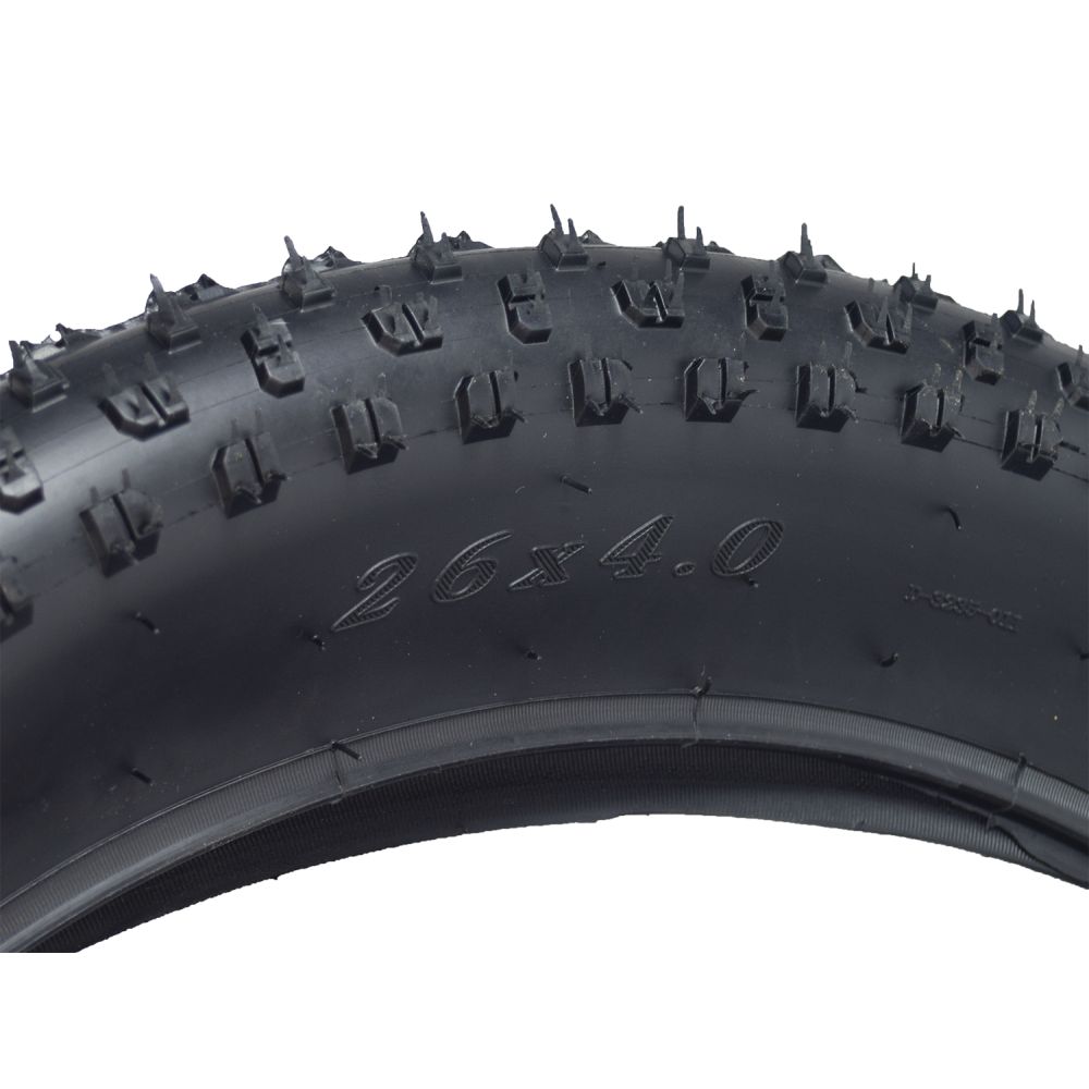 26x4.0 Tire for the Coleman DT200 Drift Trike featuring spikes and staggered corner lugs for enhanced traction on loose surfaces.