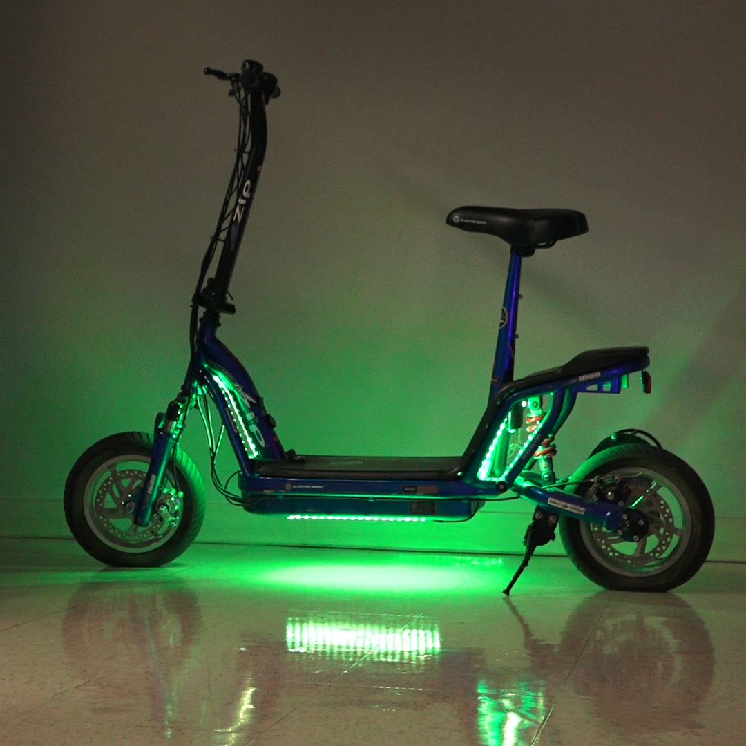 Multi-Color LED Light Kit for Recreational Scooters, featuring glowing green lights on wheels and frame, providing various lighting effects such as solid, pulsing, and flashing, controlled by a remote.