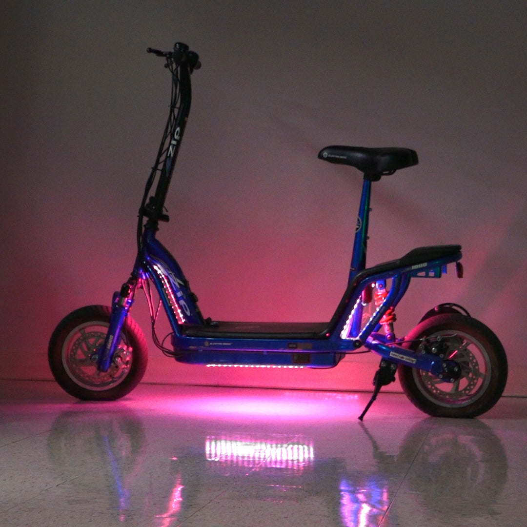 Multi-Color LED Light Kit for Recreational Scooters, shown on a blue scooter with pink lights, highlighting the wheel and light effects.