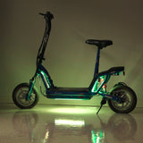 Multi-Color LED Light Kit for Recreational Scooters shown installed on a scooter, illuminating with vibrant lights, highlighting wheels and a sleek black seat, reflecting on a wet floor.