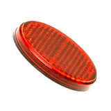 Red Rear Reflector for the Go-Go Elite Traveller, featuring a circular design with black lines and an adhesive back, ideal for enhancing scooter visibility and safety. Measures 45 mm in diameter.