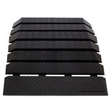 36 Wide Pride Mobility Rubber Threshold Ramp Kit, a black rubber mat with interlocking sections and holes, designed for accessibility with a slip-resistant surface, visible casting bubbles, and mold-release wax.