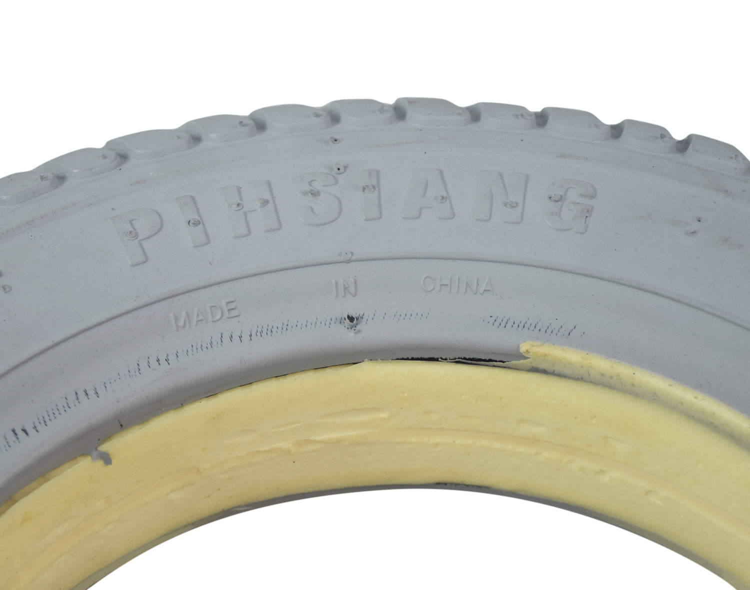 Close-up view of the 14 Gray Flat-Free Tire for the Shoprider 6Runner 14, showcasing its durable tread pattern and synthetic rubber construction for a reliable, worry-free performance.