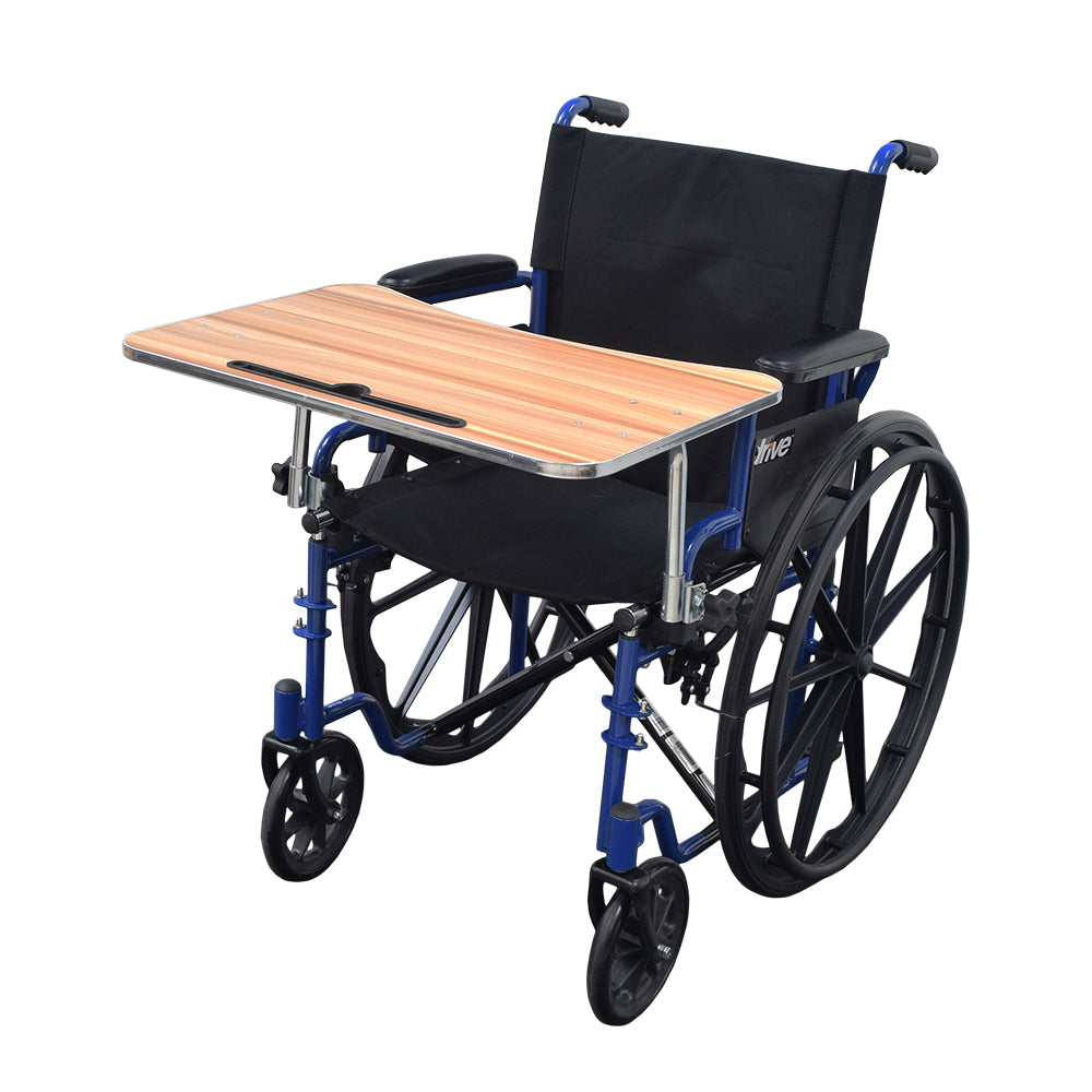 Wood Veneer Tray Table for Wheelchairs (Blemished) attached to a wheelchair, featuring a textured woodgrain surface, folding steel supports, and easy-to-turn adjustment knobs securing it to the frame.