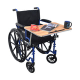 Wood Veneer Tray Table for Wheelchairs shown attached to a wheelchair, featuring a black mug, an open book, and a chip bag on its surface, emphasizing its practical use and convenience.