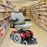 Keypad for 4 Key VSI Joystick Controllers shown on a motorized wheelchair, featuring buttons for battery meter, on/off, speed adjustment, horn, and maximum speed indicator, designed for various power chair models.