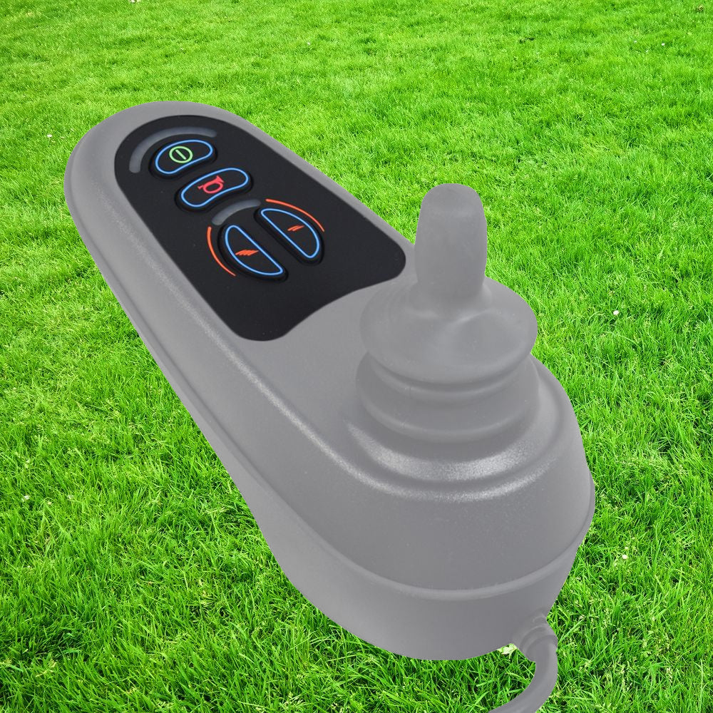 Keypad for 4 Key VR2 Joystick Controller shown on grass, featuring a grey device with buttons and a cord, ideal for replacing worn keypads on mobility power chairs.