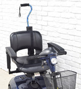 Cane Holder for Golden Scooters & Power Chairs, featuring a secure basket attachment, adjustable nylon strap, and ripstop fabric pouch for canes up to 2-3/4 in diameter, mounted on a scooter.